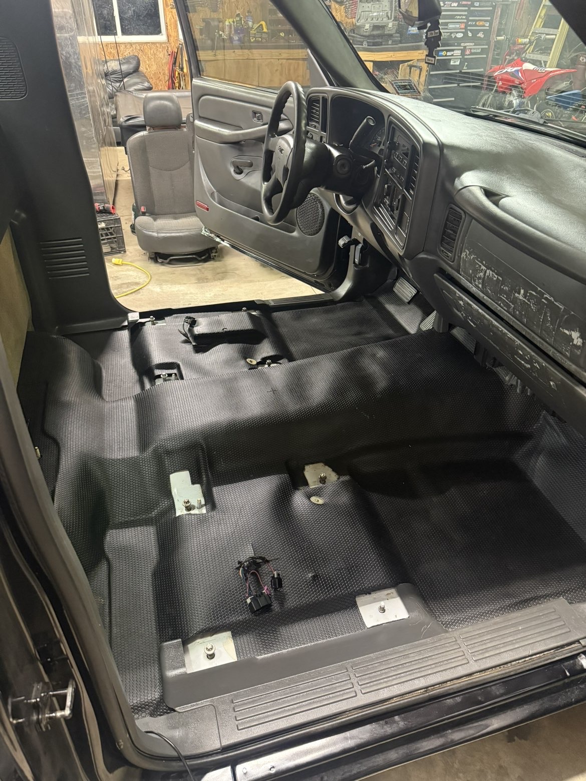 Passenger-side cab floor cleaned with mats pulled after