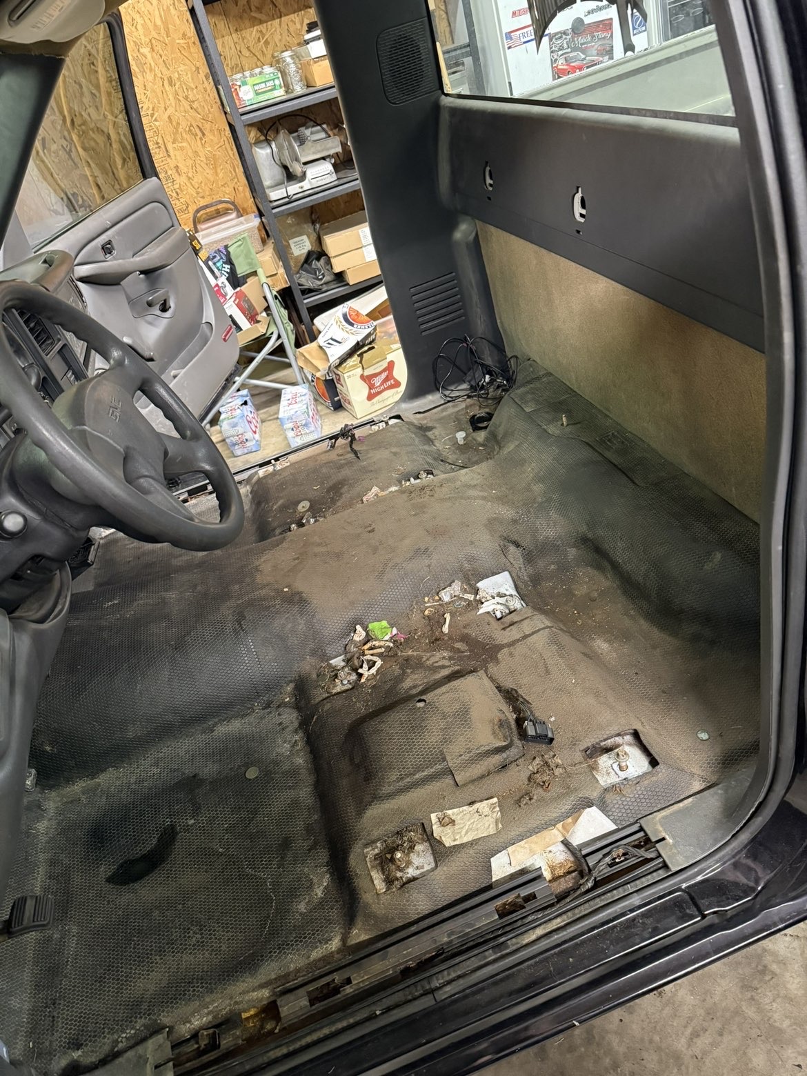 Driver-side cab full of trash and debris before