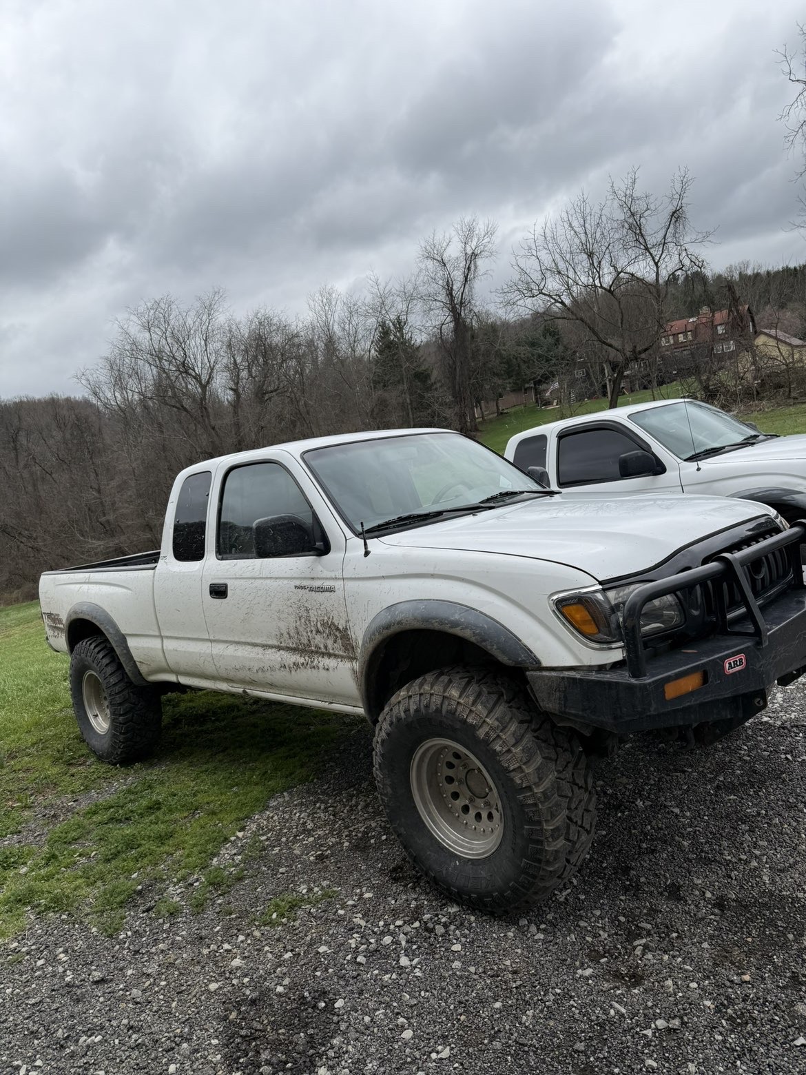 Muddy white Tacoma before detail